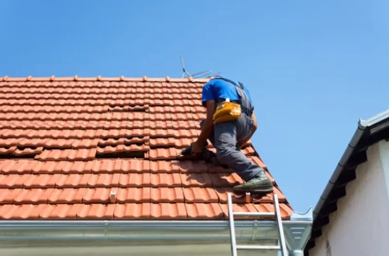 Roofers working on emergency roof repairs