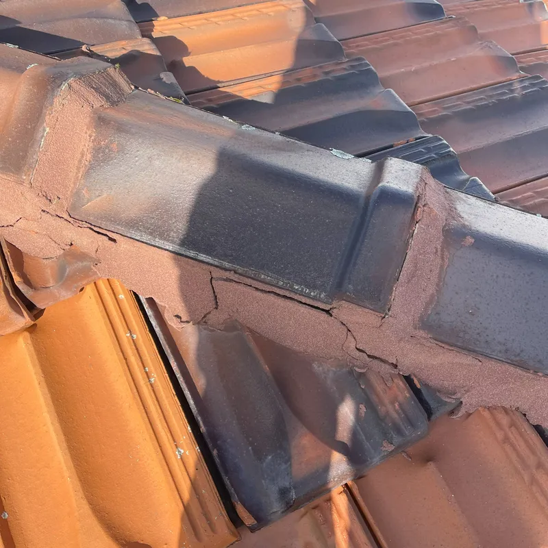 Close-up of cracked and deteriorated roof pointing on a Perth home