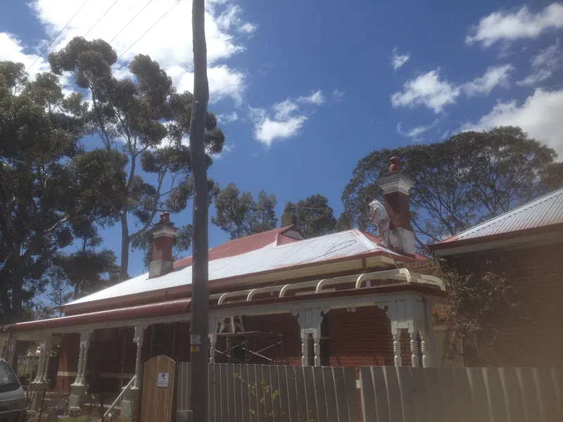 A photo of a metal roof being coated by Roof Restorers Perth
