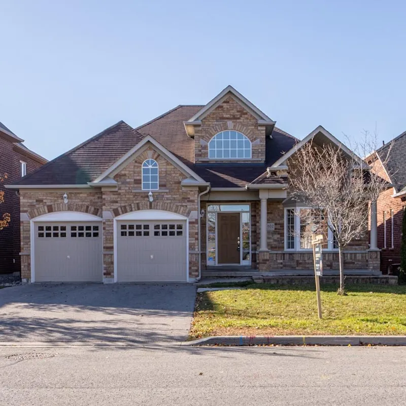 Suburban home with visible roof requiring seasonal maintenance