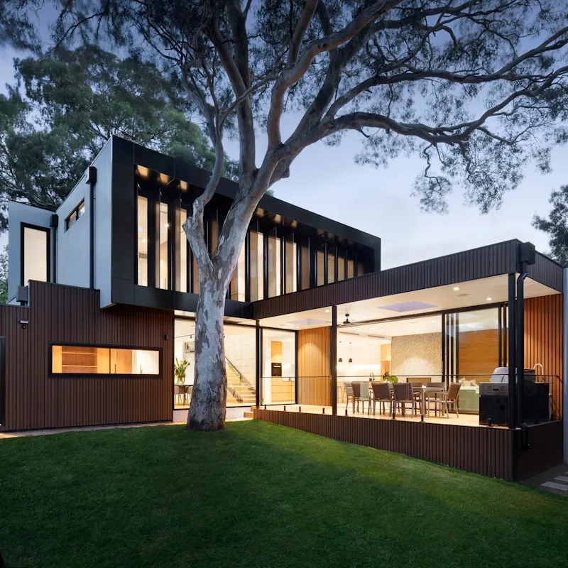 Large tree with branches overhanging a residential roof in Perth